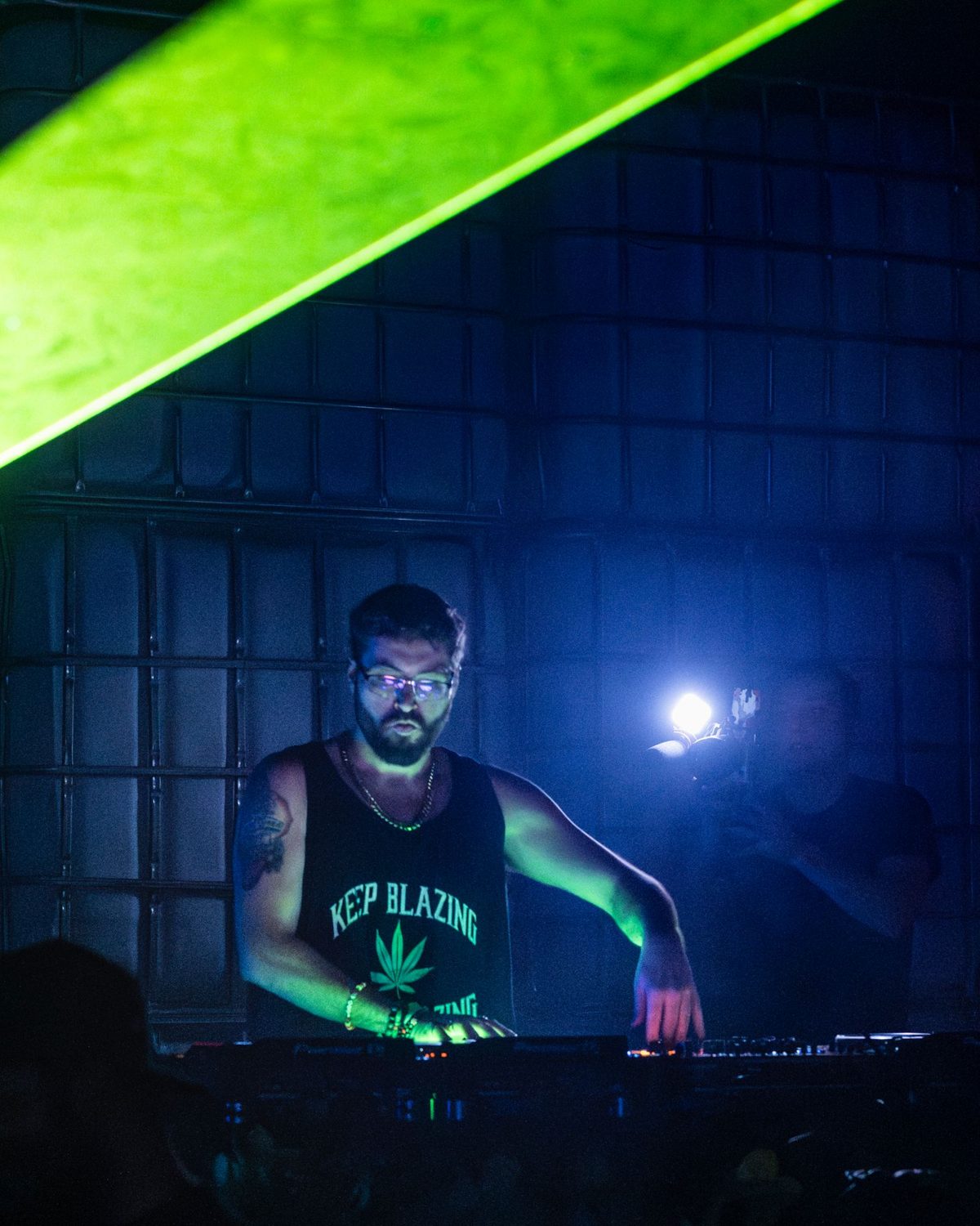 Citron playing a set under a green laser